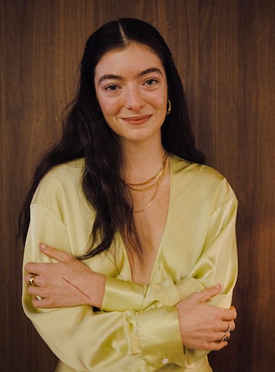 a woman with long hair wearing a yellow dress