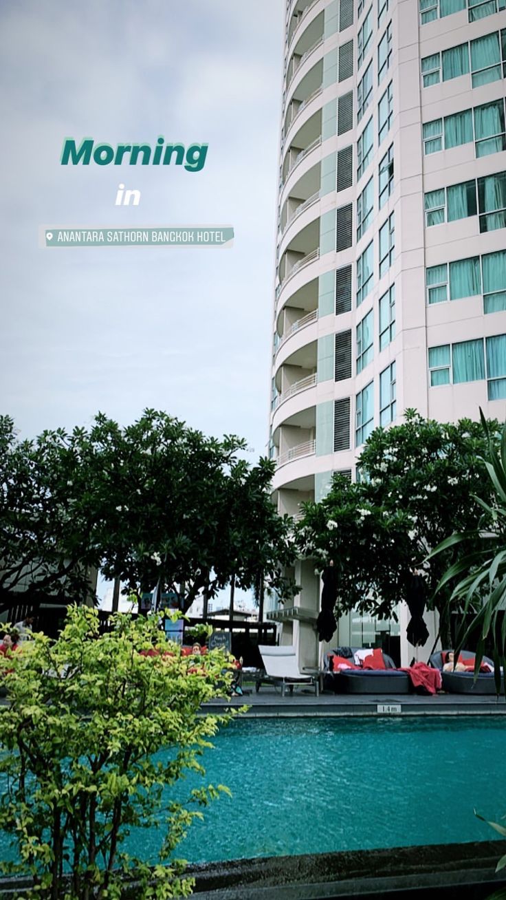 a tall building sitting next to a swimming pool