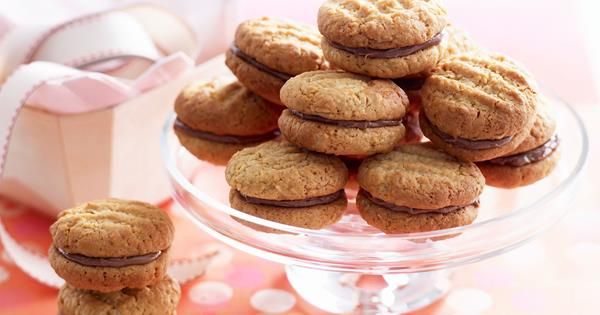 a glass plate filled with cookies on top of a table