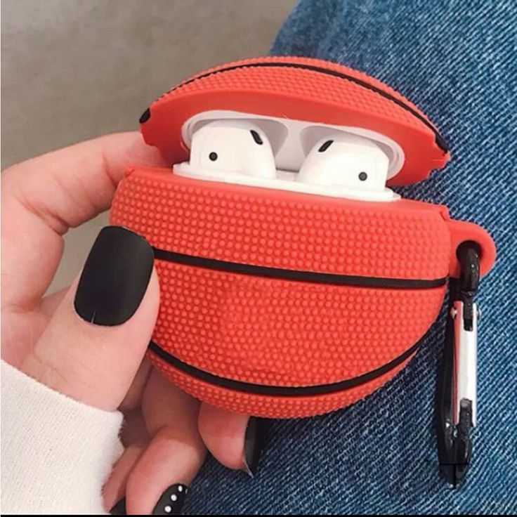 someone holding an airpods case in their hand