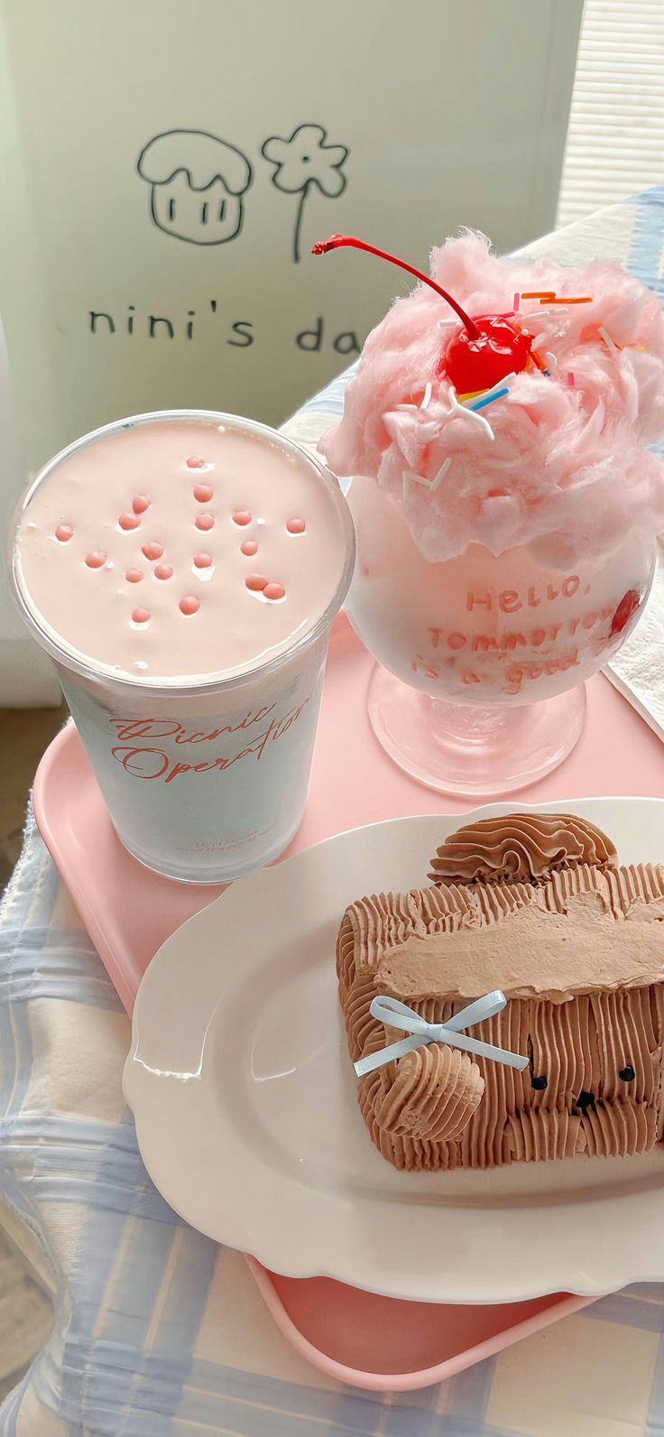 two desserts are sitting on plates next to ice cream and a cup with a straw in it