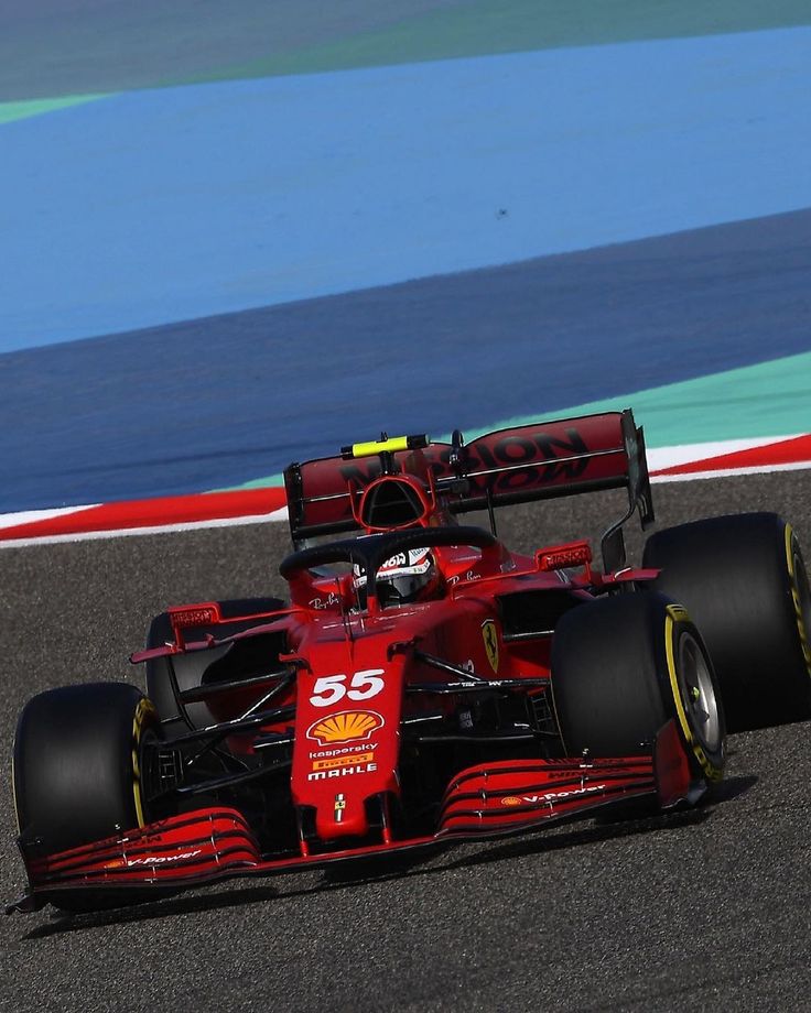 a red race car driving on a track