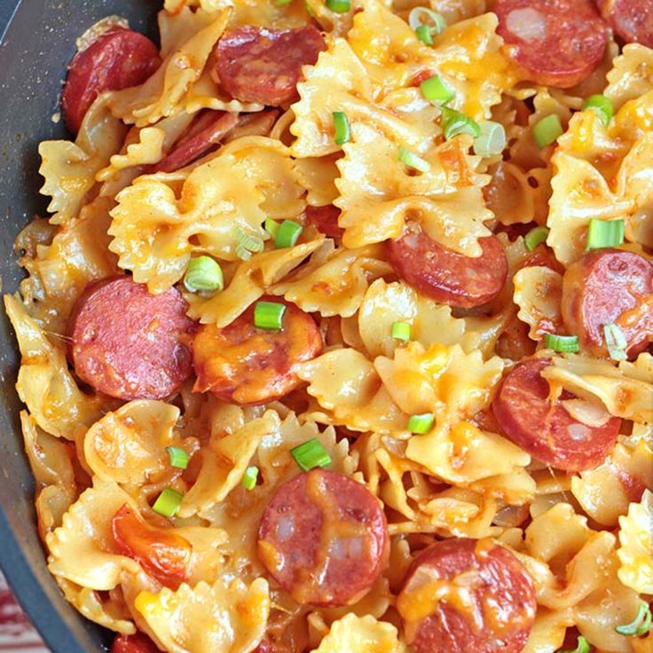 a close up of a plate of pasta with pepperoni