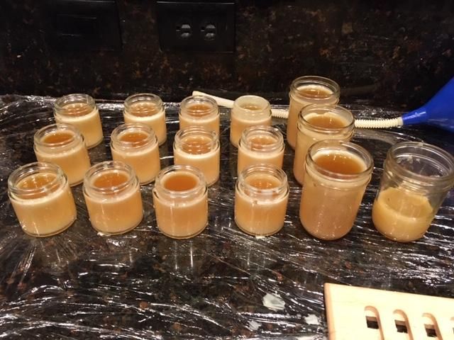 several jars filled with liquid sitting on top of a counter