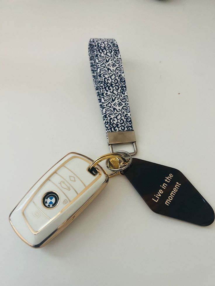 a car key chain with a bmw logo on it and a lanyard tag attached to it