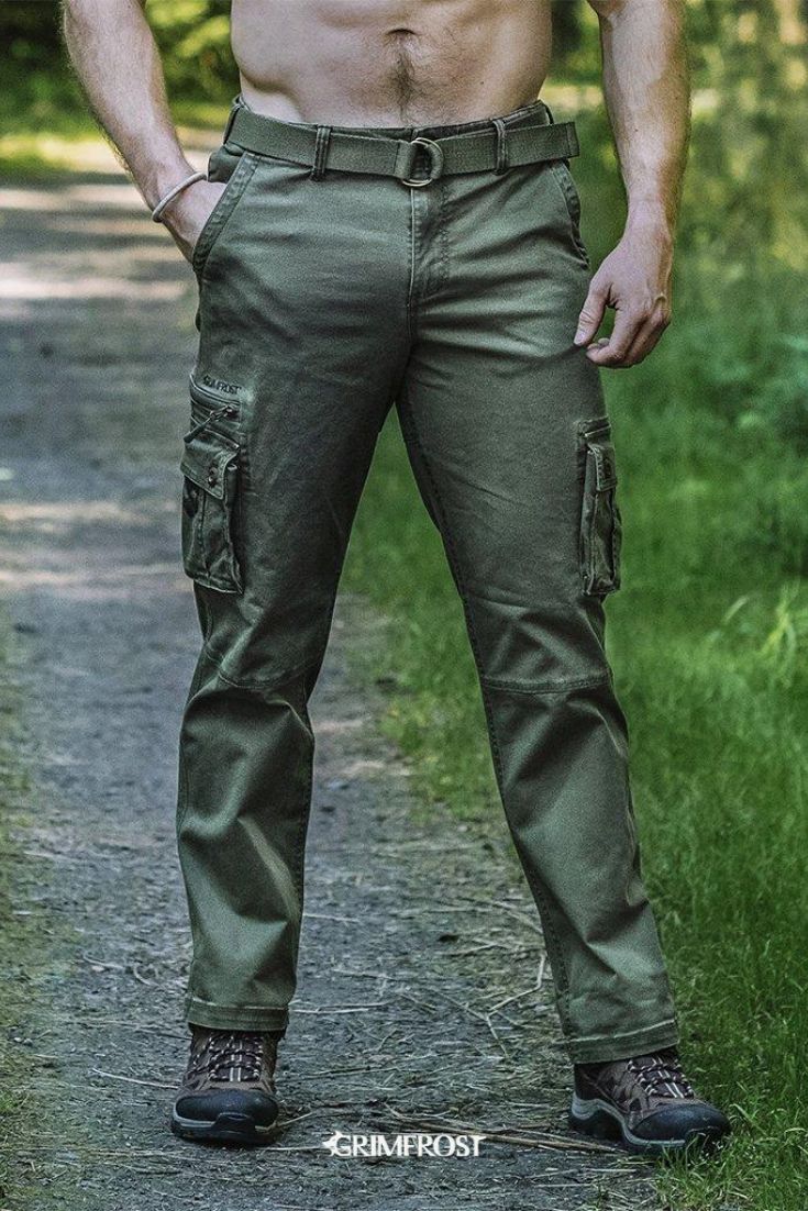 Unique cargo pants made from green high-density twill that will stand the test of time. They have a vintage garment wash, come with a robust, woven belt and a reinforced backside. With no less than pockets, they will hold and hide most of your belongings. Inspired by the past and made for the modern Viking, the pants come with a Viking twist with Grimfrost's helmet design on the pockets, a belt loop with Viking artwork and Younger Futhark runic circle buttons. #grimfrost Cotton Combat Cargo Pants For Outdoor, Combat Style Cargo Pants With Belt Loops For Outdoor, Military Style Hiking Pants With Pockets, Combat Style Cargo Pants For Outdoor Activities, Combat Style Full-length Cotton Cargo Pants, Combat Style Cotton Cargo Pants, Combat Style Cargo Pants With Multiple Pockets, Military Pants With Patch Pockets For Outdoor, Military Pants With Patch Pockets For Outdoor Activities