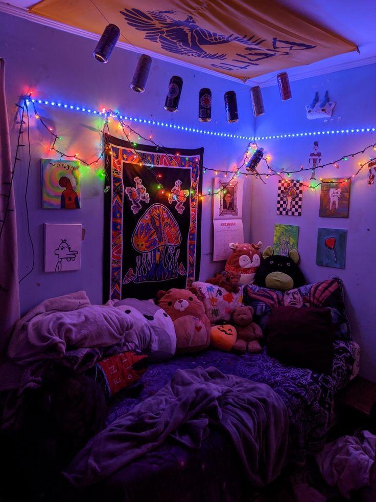 a bedroom with lights and stuffed animals on the bed in front of an art work