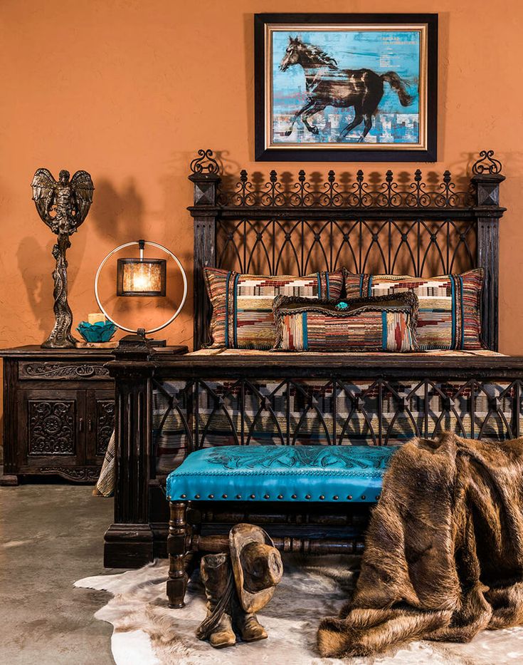 a bedroom with an ornate bed and blue pillows