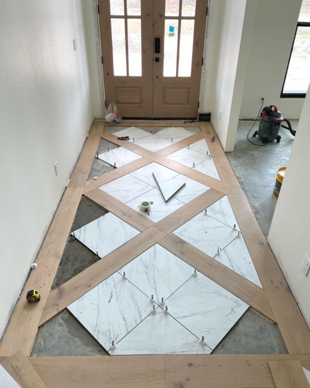 the floor is being laid out in front of the door to be installed on the side of the house