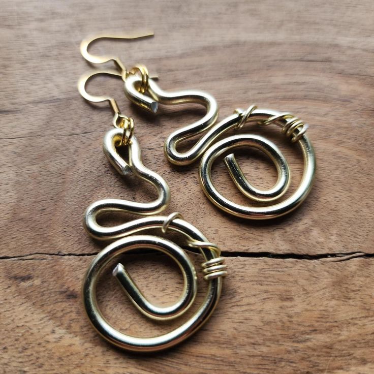 ・✧・ॐ・✧・ Handmade Om earrings. On Hypo Allergenic rings. Made with love and care. 🌿✨️ Spiral Earrings With Ear Wire As Gift, Spiral Earrings With Ear Wire For Gifts, Symbolic Drop Earrings Jewelry As Gift, Symbolic Drop Earrings As A Gift, Adjustable Cadmium-free Hoop Earrings As Gift, Symbolic Hypoallergenic Metal Jewelry, Handmade Spiral Earrings As Gift, Wire Wrapped Metal Hoop Earrings As Gift, Handmade Spiral Earrings For Everyday