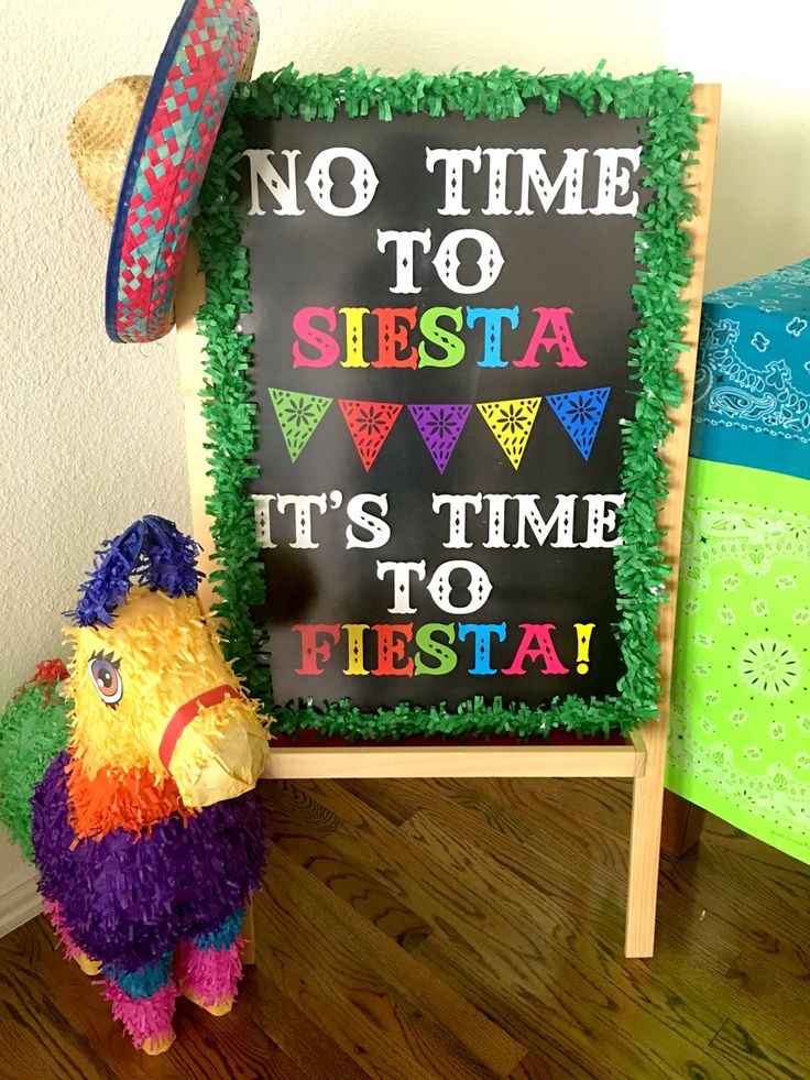 a stuffed animal next to a sign that says no time to sista it's time to fiesta