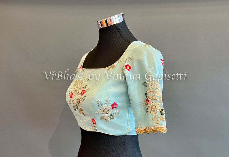 Blouse size: 34 All the Blouses have enough room to adjust to next two sizes above or below the standard size. Elegant Blue Blouse Piece With Intricate Embroidery, Blue Floral Embroidery Blouse Piece For Party, Blue Floral Embroidery Blouse For Party, Elegant Short Sleeve Top With Resham Embroidery, Blue Blouse Piece With Floral Embroidery For Party, Blue Georgette Blouse Piece With Floral Embroidery, Blue Party Blouse With Floral Embroidery, Elegant Short Sleeve Blouse With Floral Embroidery, Blue Blouse With Intricate Embroidery For Party