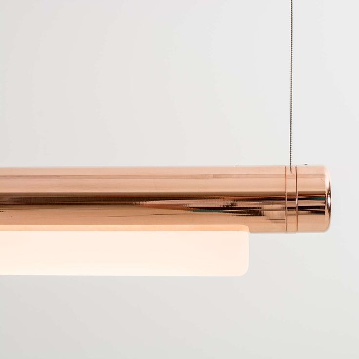 the light fixture is made from copper and has a white cord hanging from it's end