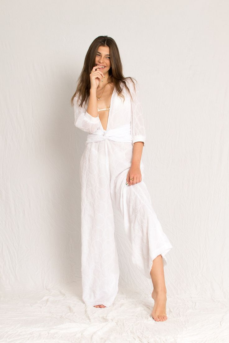 White sheer jumpsuit with sleeves, open V neckline and georgette silk lining Beachy V-neck Swimwear For Spring, Fitted V-neck Swimwear For Beach Cover-up, Fitted Beachwear Cover-up For Brunch, Chic V-neck Beach Dress For Loungewear, Chic V-neck Beach Dress, Fitted V-neck Cover-up For Beach Party, White V-neck Swimwear For The Beach, Summer V-neck Unlined Cover-up, V-neck Swimwear For Beach Season