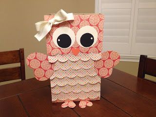 an owl made out of paper sitting on top of a table