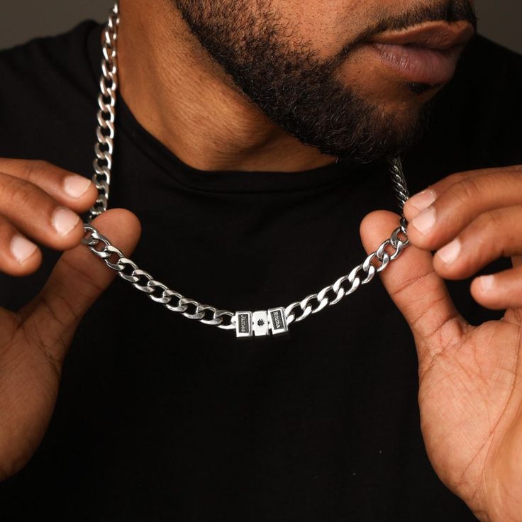 Men's Cuban Link Chain has been expertly designed and crafted to achieve the ideal length, weight, and shine while also providing a comfortable fit for everyday wear. The necklace comes with a distinctive black diamond charm. This striking detail adds a touch of sophistication and luxury to an already exceptional accessory. Personalize it with your own unique touch by adding a special date, the names or initials of your loved ones, and create a truly one-of-a-kind piece of jewelry. Birthstone Earrings Studs, Silver Cuban Link Chain, Stainless Steel Bracelet Men, Mens Silver Necklace, Classic Bracelets, Classic Necklace, Engraved Bracelet, Diamond Cross, Solid Gold Jewelry