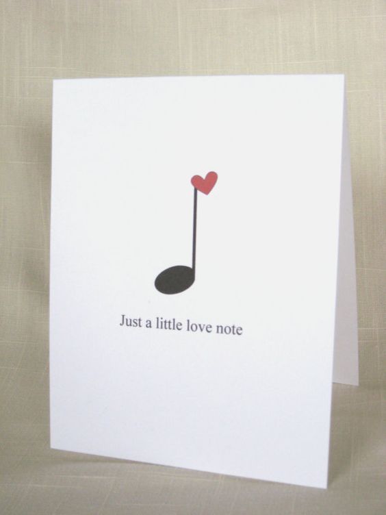 a white card with a red heart in the shape of a golf club on it