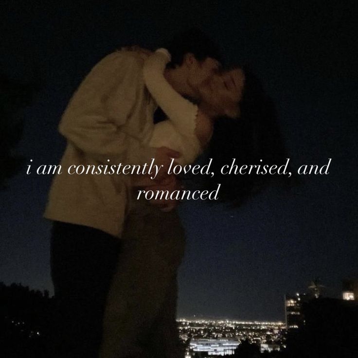 a man and woman kissing in front of a city at night with the words i am constantly loved, cherished, and romance