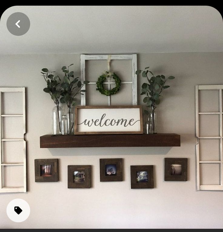 there is a welcome sign on top of the shelf above the bed and four framed photos