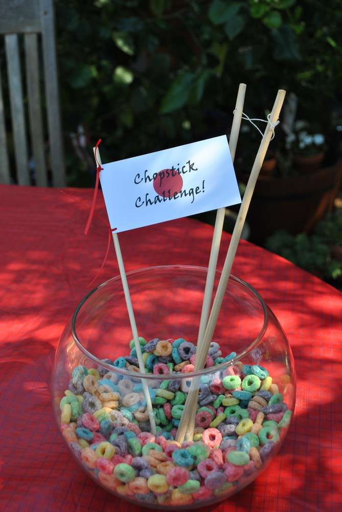 a bowl filled with lots of cereal sitting on top of a table next to a sign