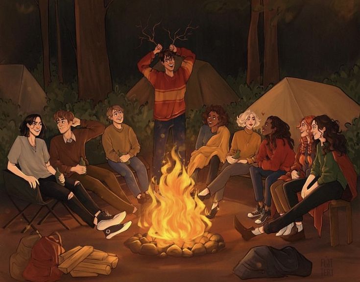 a group of people sitting around a campfire