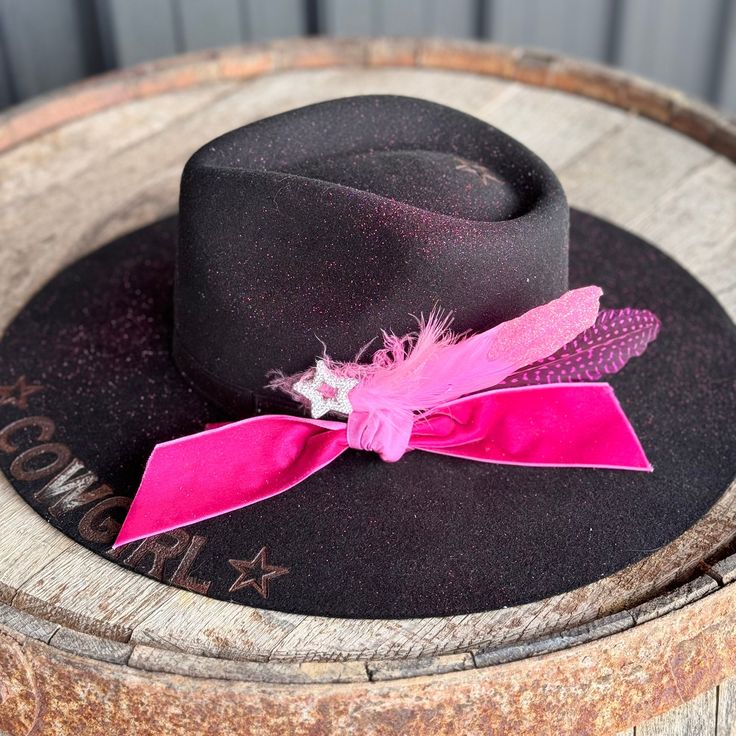 Doll up your little cowgirl with this black felt Charlie 1 Horse decorate with Hot Pink velvet ribbon and matching pink feathers Cowgirl & Stars branded with fire branding on the brim and matches the rhinestone star accent Sprinkled with some hot pink glitter like sugar across the crown and brim top side Junior size youth hat one size fits most Pink Felt Hat With Short Brim For Country Events, Black Top Hat For Kentucky Derby And Country Events, Custom Black Hat Bands For Kentucky Derby, Pink Short Brim Felt Hat For Country Events, Custom Black Felt Hat For Country Events, Pink Western Wide Brim Costume Hat, Pink Short Brim Hat For Western-themed Events, Pink Fedora For Western-themed Events, Pink Brimmed Hat For Rodeo