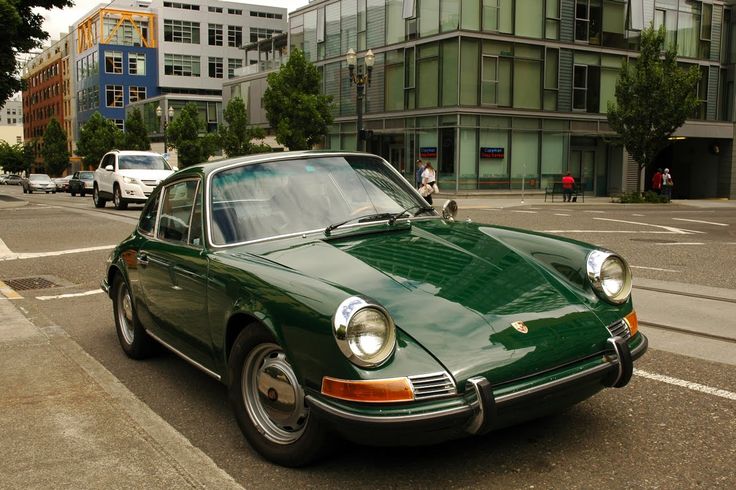 a green car parked on the side of the road