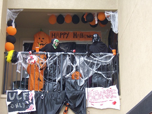 halloween decorations are displayed on the balcony of a house