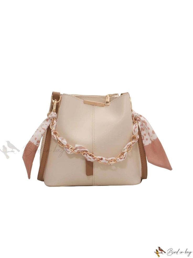 Bird in Bag - Elegant Bucket Bag with Skinny Scarf and Chain Decoration Beige Bucket Bag With Chain Strap, Beige Bucket Shoulder Bag With Chain Strap, Beige Shoulder Bucket Bag With Chain Strap, Trendy Cream Bag With Chain Strap, Chic Cream Bag With Chain Strap, Everyday Cream Bag With Chain Strap, Elegant Beige Bag With Chain Detail, Beige Chain Shoulder Bag For Formal Occasions, Formal Beige Shoulder Bag With Chain Detail