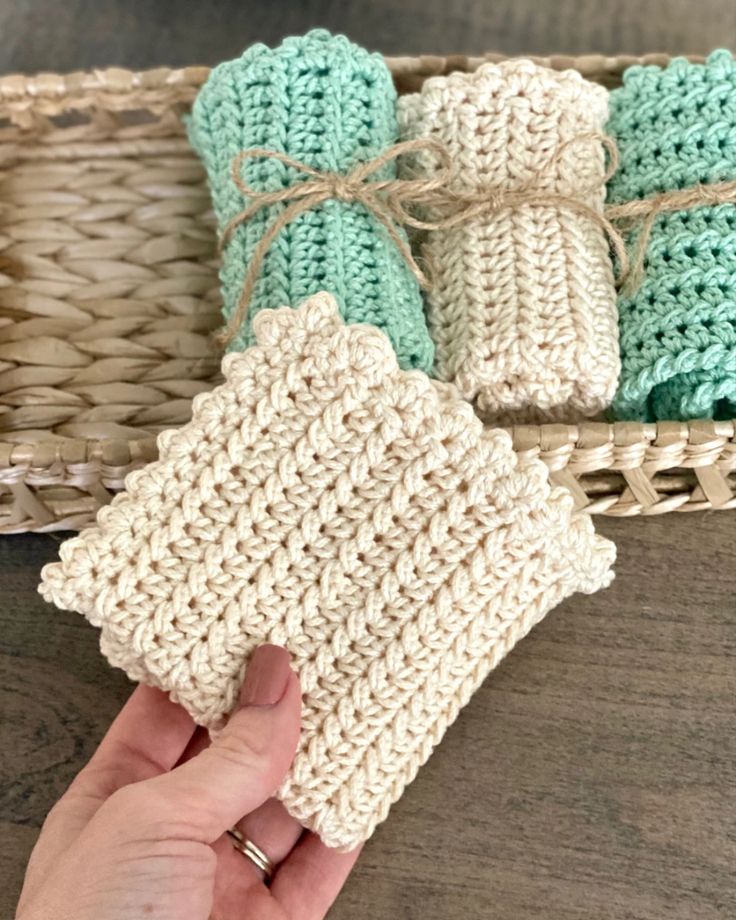 a hand holding a crochet dish cloth with the words farmhouse dish cloth written on it