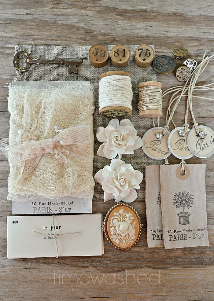 an assortment of items are displayed on a wooden surface with tags and other things to sew