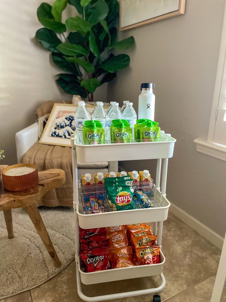 a white cart filled with drinks and snacks