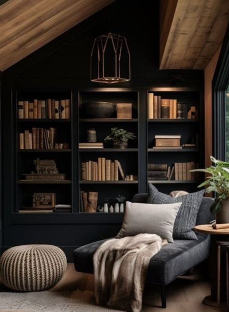 a living room filled with furniture and bookshelves covered in lots of shelves next to a window