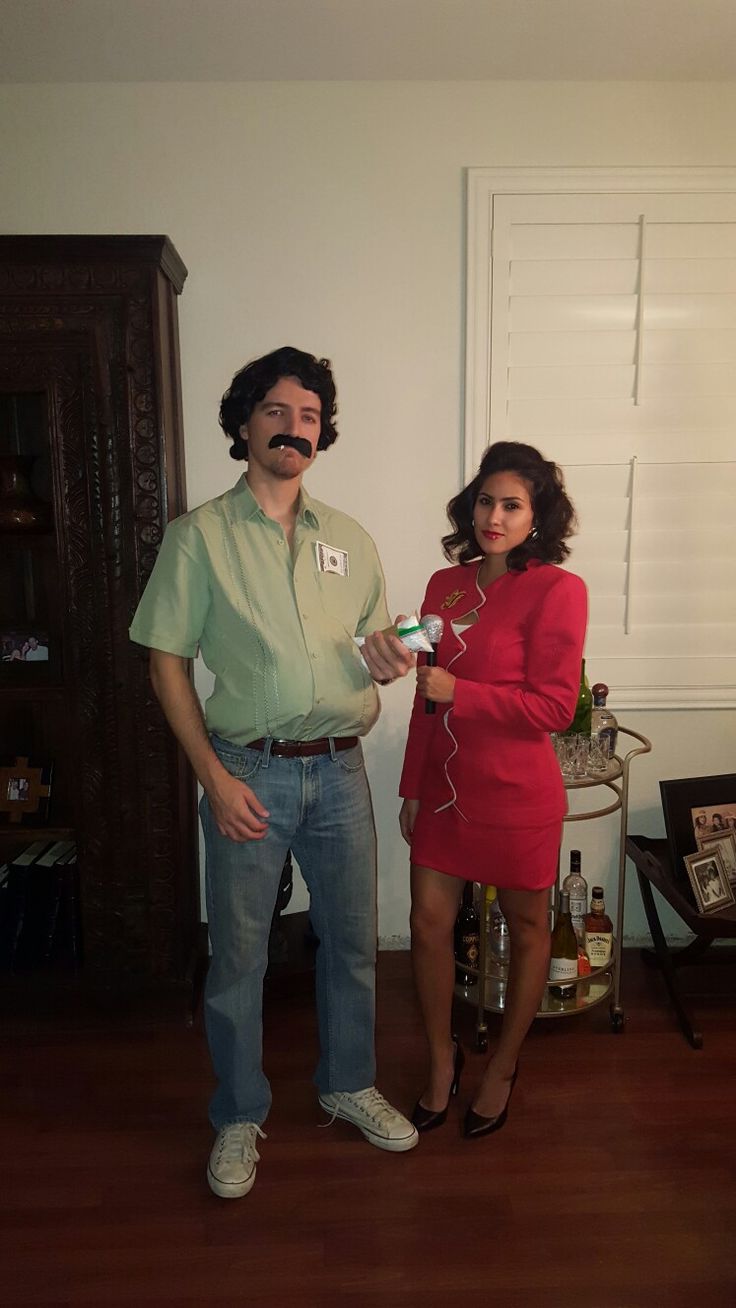 a man standing next to a woman in a living room holding a toothpaste