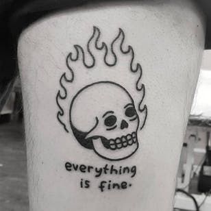 a black and white photo of a skull with fire on it's leg that says everything is fine