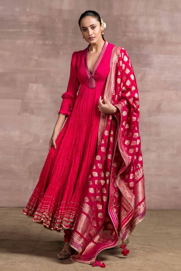 Bright fuchsia anarkali in silk crinkle fabric with brocade detailing on the neckline and hem. Paired with Banarasi dupatta with tassel detailing and churidar.
Component: 3
Embroidered
Neckline: V-neck
Sleeve Length: Three quarter
Fabric: Kurta: Silk, Dupatta: Handloom Silk, Churidar: Stretch Net
Color: Pink
Banarasi dupatta
Crush texture
Brocade border
Disclaimer - The handloom dupatta may vary in terms of the motifs and colours depending on the availability - Aza Fashions Silk Anarkali Churidar For Transitional Season, Pink Anarkali Salwar Kameez With Zari Weaving, Anarkali Silk Churidar With Self Design, Banarasi Silk Anarkali Set With Dupatta, Anarkali Set With Dupatta In Banarasi Silk, Traditional Anarkali Set In Slub Silk, Anarkali Set In Slub Silk With Traditional Drape, Slub Silk Anarkali Set, Festival Banarasi Silk Anarkali Set With Long Sleeves