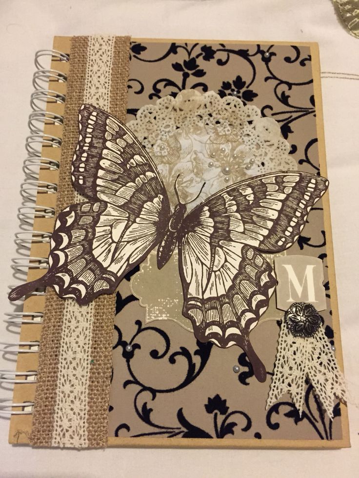 an open notebook with a butterfly on it and the word mom written in white letters