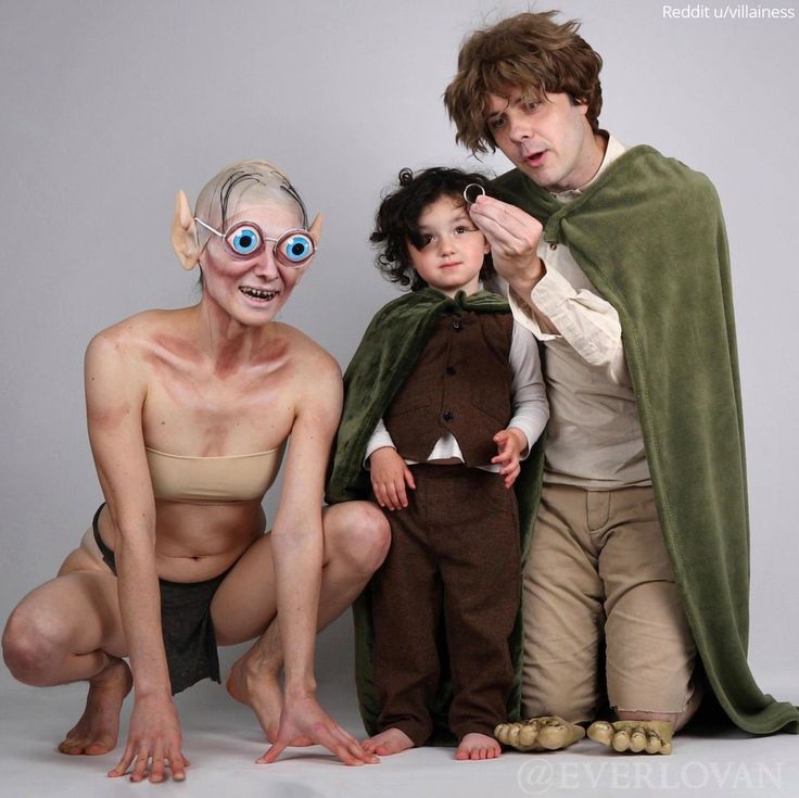 three people in costumes posing for a photo with one man dressed as an elf and the other as a child