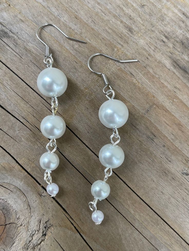 These earrings are made with white glass Pearl beads White Pearl Beaded Drop Earrings, White Pearl Drop Beaded Earrings, Pearl Beaded Drop Earrings, White Beaded Pearl Earrings, Pearl Beaded Drop Earrings For Pierced Ears, White Pearl Clip-on Earrings For Party, White Pearl Beaded Earrings For Party, Pearl White Dangling Bead Earrings, White Beaded Dangle Pearl Earrings