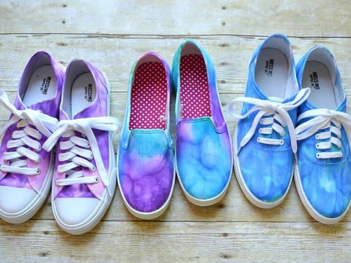 four pairs of shoes painted in different colors and sizes, all with white laces