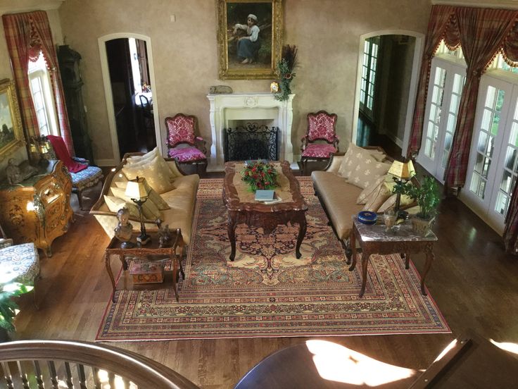 an aerial view of a living room with couches, chairs and fireplace in it