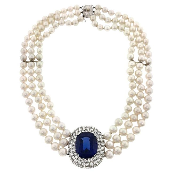 Mikimoto Tanzanite, Diamond & Pearl Choker Necklace in 18k White Gold Pearl and Tanzanite Choker by Mikimoto features a natural Cushion shaped Tanzanite weighing 30 carats estimated; set in 18k White Gold with 3 Rows of Round Brilliant Diamonds totaling 6.00 carats estimated 3 Strands of Cultured Pearls measuring 7 to 7.5 mm Beautifully matched, very high luster Necklace measures 16 inches long Center piece measures 1.25 inches long and 1.20 inches across Necklace weighs 108 grams 18k White Gold Round Diamond Pendant, The Bling Ring, Vintage Jewellery Rings, Tanzanite Jewelry, Diamond Tennis Necklace, Mikimoto Pearls, Morganite Diamond, Tanzanite Diamond, Solitaire Pendant Necklace