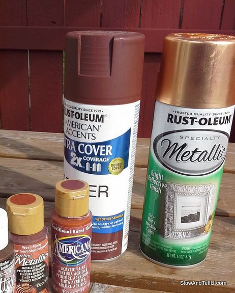 several different types of paint sitting on top of a wooden table