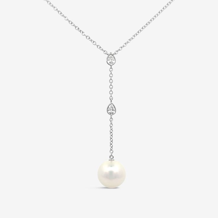 A statement piece for any stylish bride to be, this Pearl and Diamond Lariat Necklace is the perfect addition for your special day. The necklace features a two-inch gorgeous drop Pearl lariat adorned with two delicate bezel set pear shaped Diamonds. Wear with our matching earrings. White Fresh Water Pearl: 7 mm Natural Diamonds: 0.25ctw 14K White or Yellow Gold Drop: 2 Inches Length: 18 Inches Mavilo Exclusive Diamond Lariat Necklace, Stylish Bride, Pearl Lariat, Fresh Water Pearl, Earrings White, Pear Shaped Diamond, Pearl Diamond, Bride To Be, Lariat Necklace