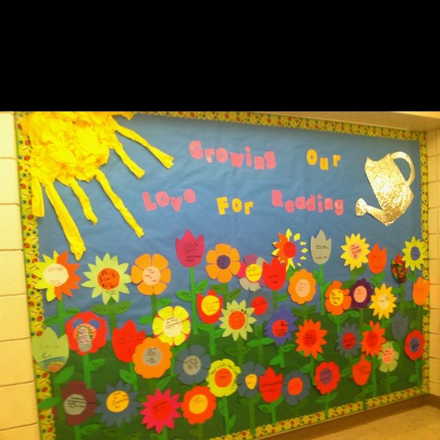 a bulletin board is decorated with flowers and the words growing our love for education on it