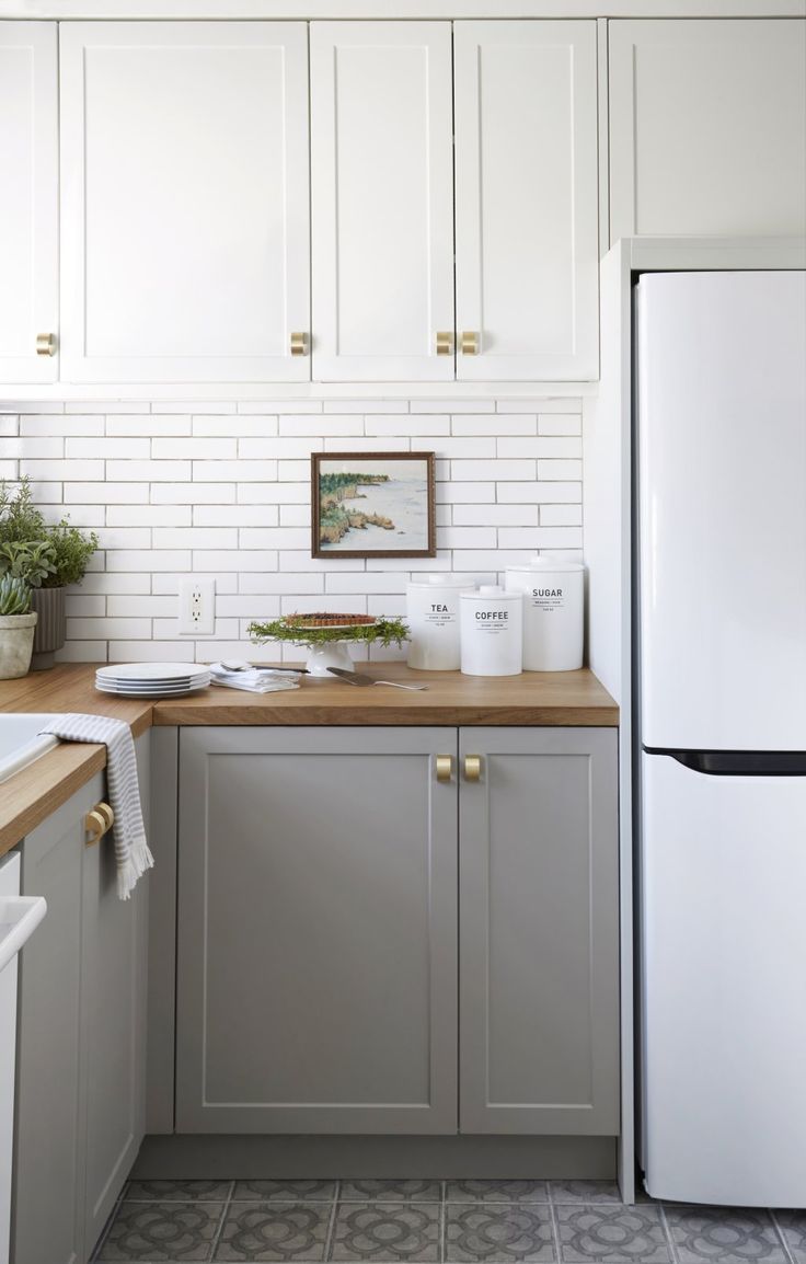 a white refrigerator freezer sitting inside of a kitchen next to a wooden counter top