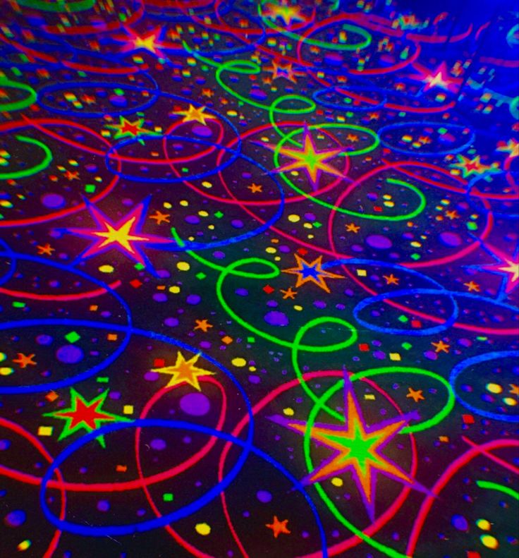 an image of colorful lights and stars on a black background with blue, green, red, yellow, and purple colors