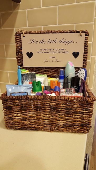 a basket with personal care items in it sitting on top of a counter next to a toilet