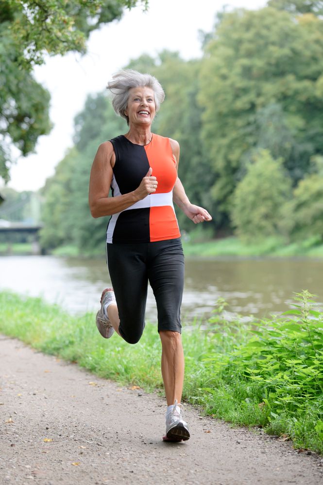 an older woman running down a path with the words run back the clock