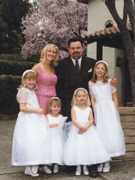 the family is posing for a photo in their dresses